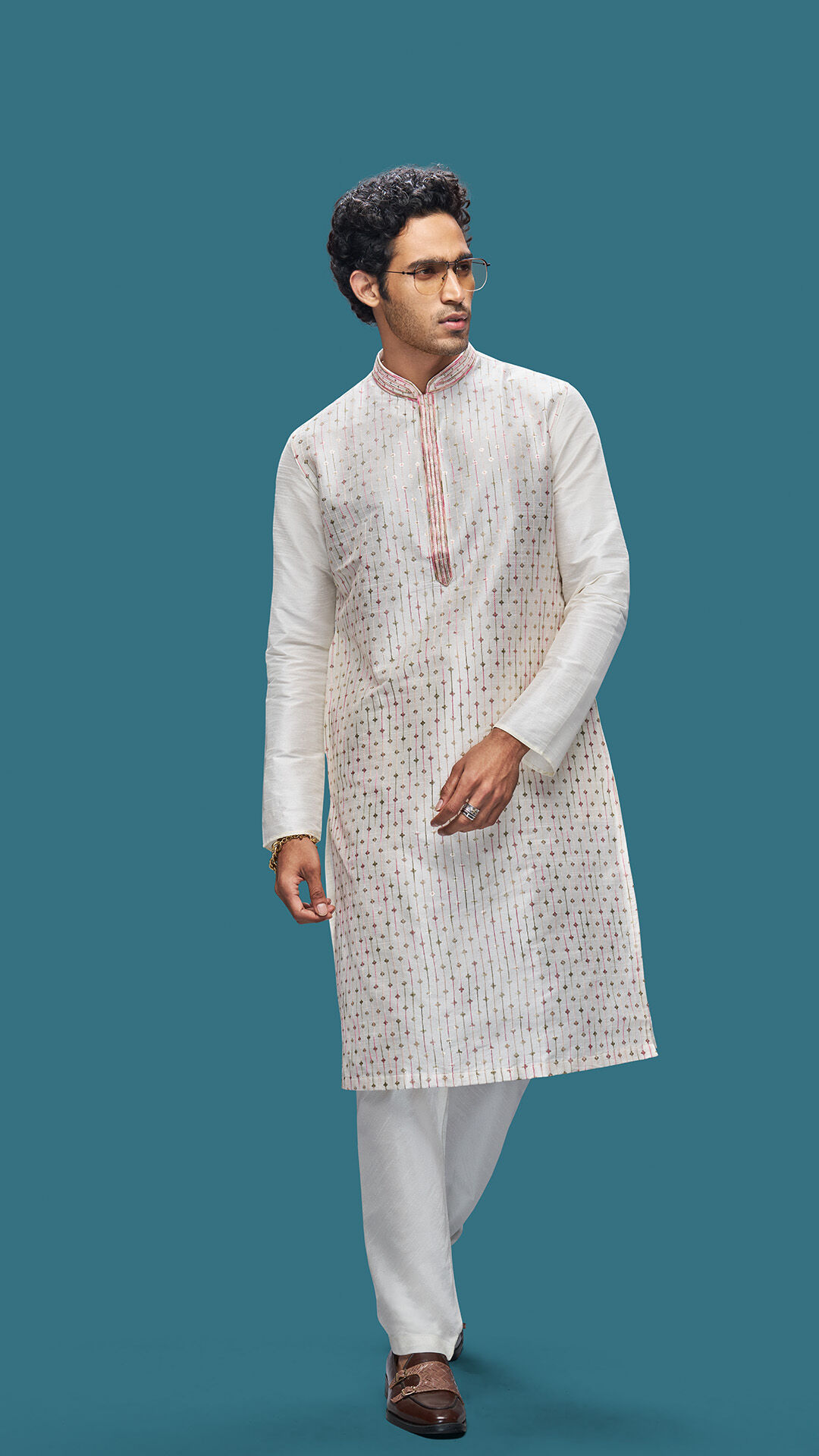 Man wearing a self-textured white kurta with subtle woven detailing and a mandarin collar